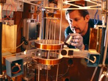 Physicist Richard Steiner adjusts the watt balance. This extremely sensitive scale can detect changes as small as ten-billionths of a kilogram.